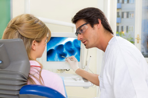 Dentist and patient in front of dental monitor